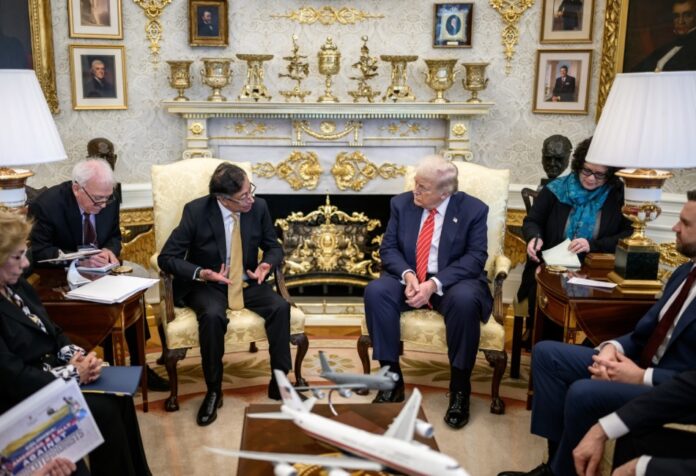 Donald Trump y Gustavo Petro sentados frente a frente en la Casa Blanca durante una reunión diplomática, acompañados por asesores de ambos gobiernos.