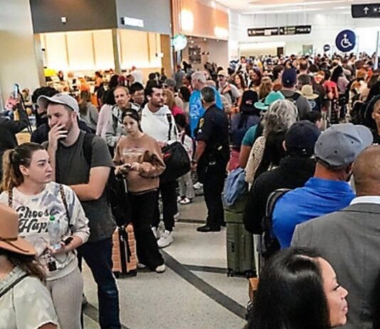 Se paraliza parcialmente gobierno federal de EE.UU. por la falta de un acuerdo presupuestario Multitud de pasajeros haciendo largas filas dentro de un aeropuerto en Estados Unidos, con áreas saturadas y personal limitado, en un contexto de afectaciones operativas por falta de pago a trabajadores federales.