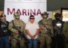 Capturan a “El Jardinero”, operador clave del CJNG en operativo de inteligencia Hombre detenido con los ojos cubiertos, custodiado por elementos armados de la Marina y fuerzas de seguridad en México durante su presentación oficial.