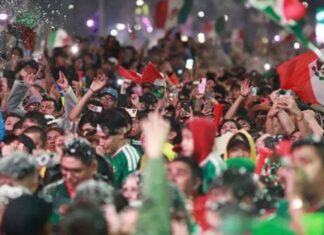 La alegría también necesita prudencia Multitud de aficionados mexicanos celebrando con banderas, luces y teléfonos durante festejos futboleros.