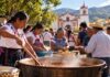 Cambiar de religión no solo cambia la fe, a veces cambia la manera de pertenecer a la comunidad Comunidad tradicional de Oaxaca participa en la preparación colectiva de alimentos frente a una iglesia durante una celebración comunitaria.